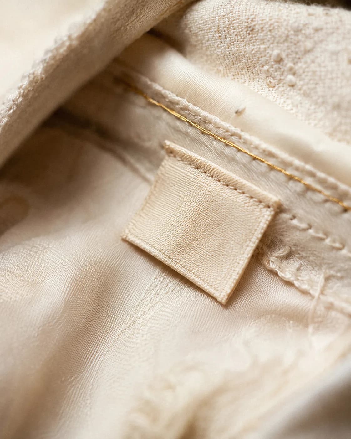 Close detail of an authenticated vintage garment label and stitching