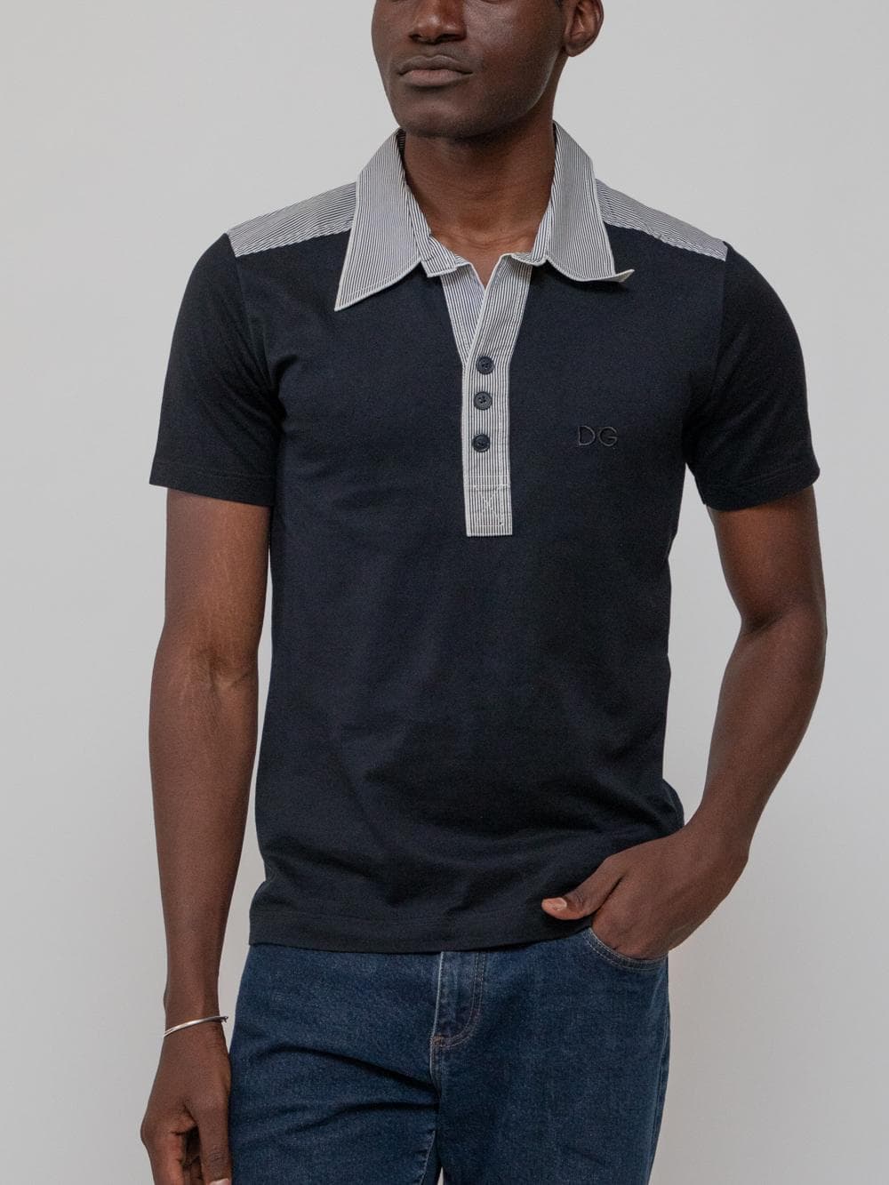 Summer early 00's polo shirt with faded black and white striped point collar, shoulders, and three button placard, and black body - Image 1