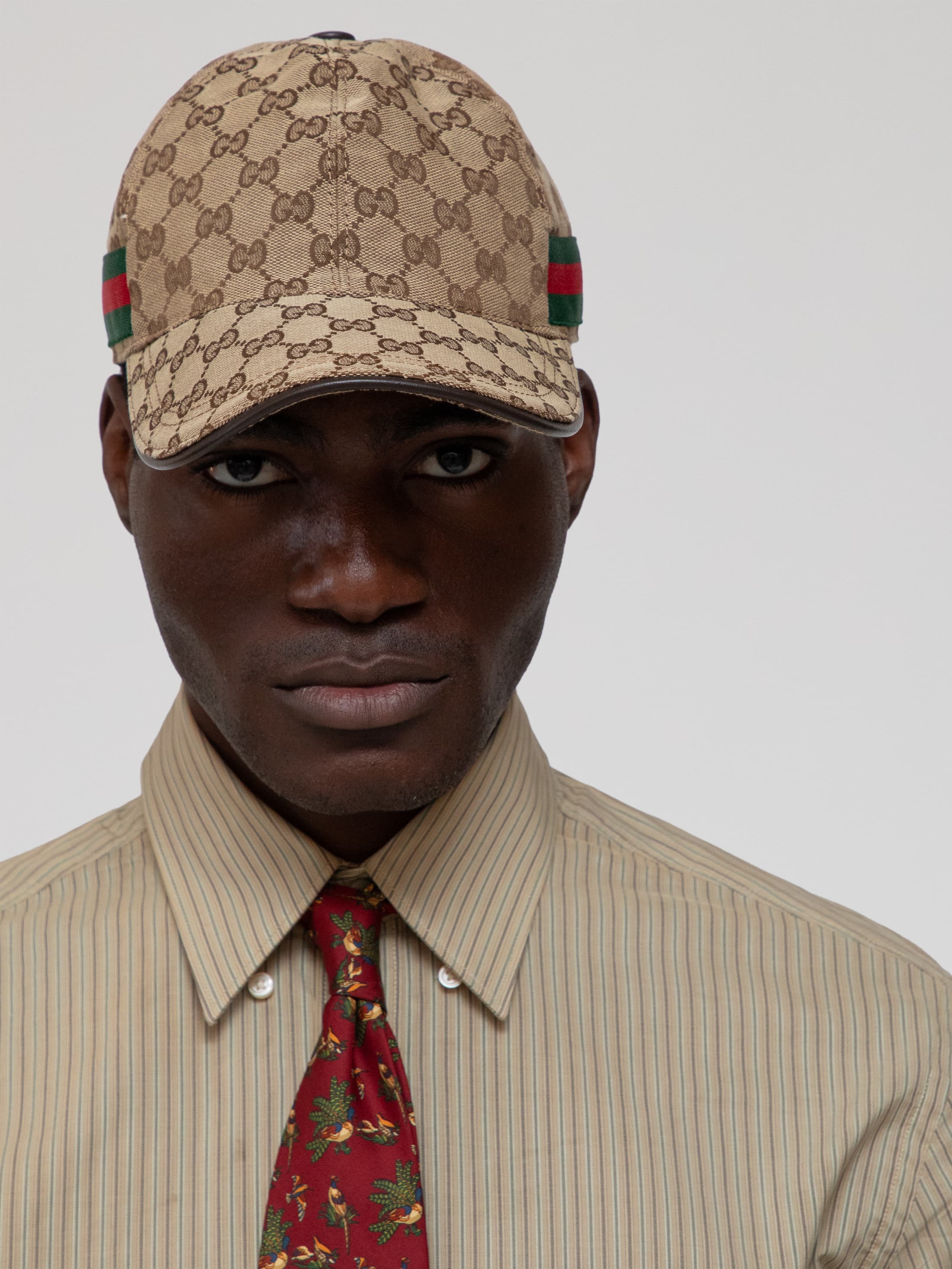 Mid 00s baseball cap with all over Gucci logo print and Gucci stripes on each side, with leather top centre button and visor trim and velcro/leather adjuster - Image 1