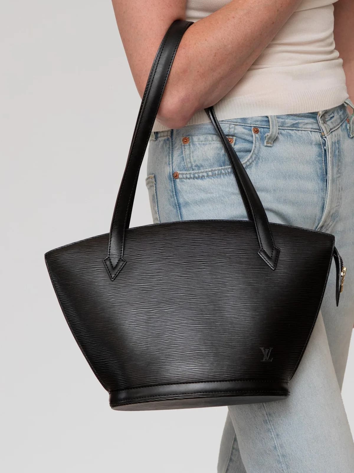 Meticulously crafted from Noir Epi leather with its signature textured wave grain, this vintage Louis Vuitton Saint Jacques shoulder bag showcases a sculptural fan-shaped silhouette finished with smooth dual shoulder straps and a discreetly debossed LV logo. - Image 1