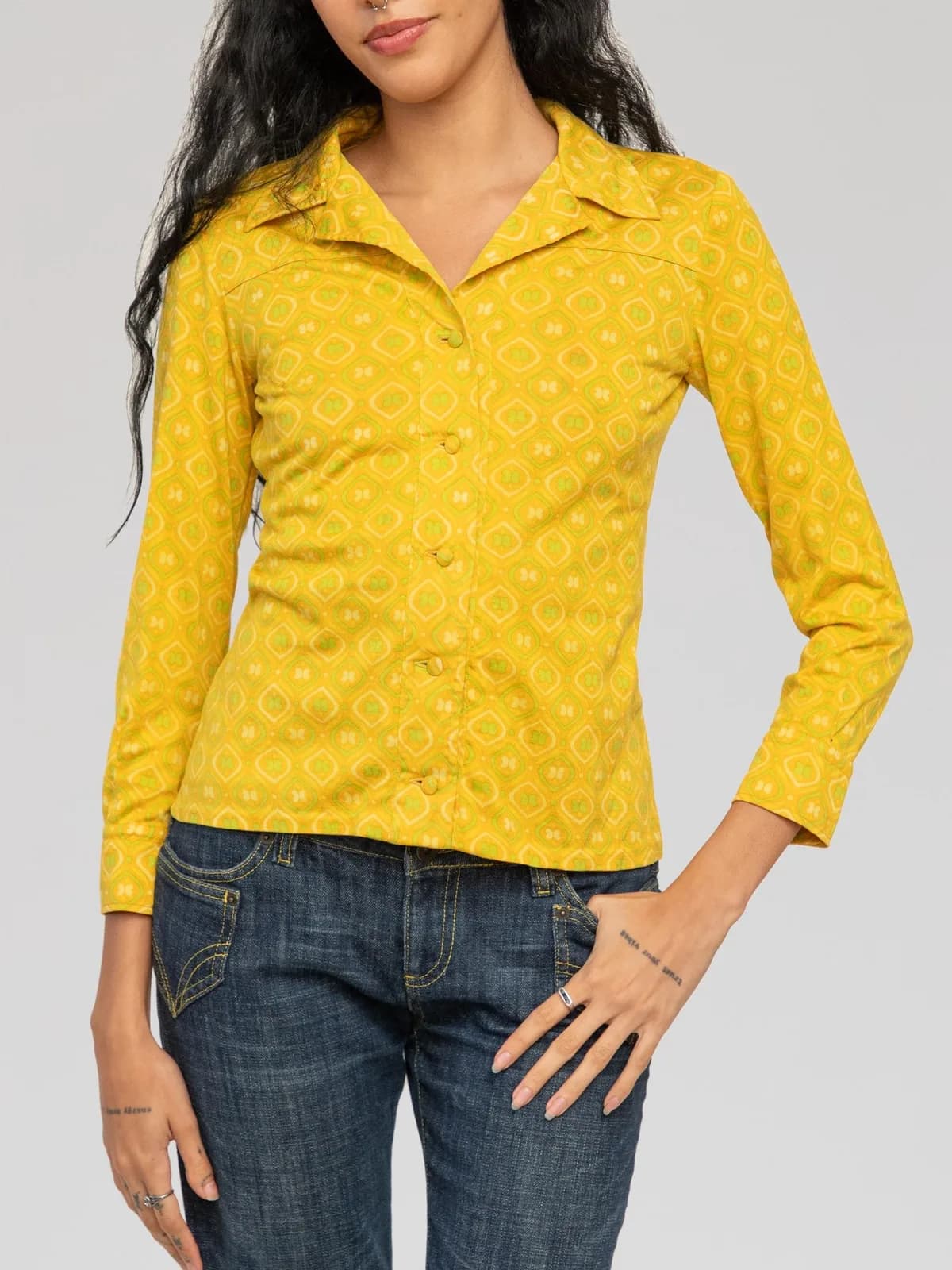 Christian Dior long-sleeve geometric print shirt rendered in a vibrant mustard yellow with lime green and white retro tile motifs, featuring a wide pointed collar, covered front button closures, subtle yoke detailing across the chest and back, and single-button barrel cuffs. - Image 1