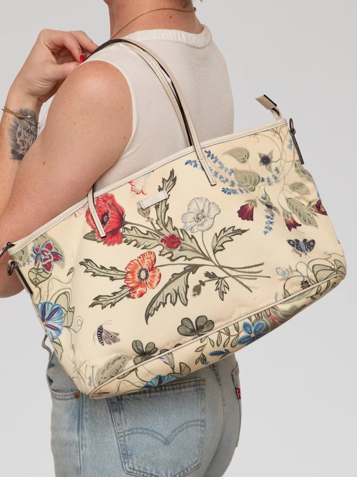 Featuring a vibrant botanical print designed in collaboration with artist Kris Knight, this Gucci canvas tote is framed by off-white leather trim and slim shoulder handles for a romantic, artful touch. - Image 1