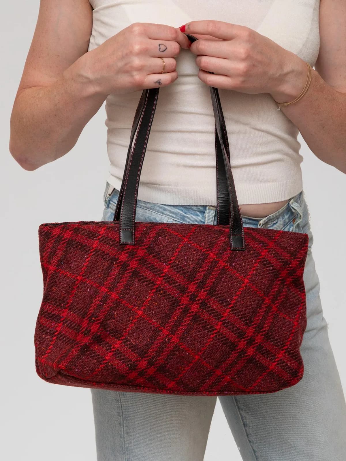 Woven in a cozy deep red and burgundy plaid wool tweed, this vintage Burberry shoulder bag is finished with black leather double straps and contrast red stitching for a rich, tactile heritage look. - Image 1