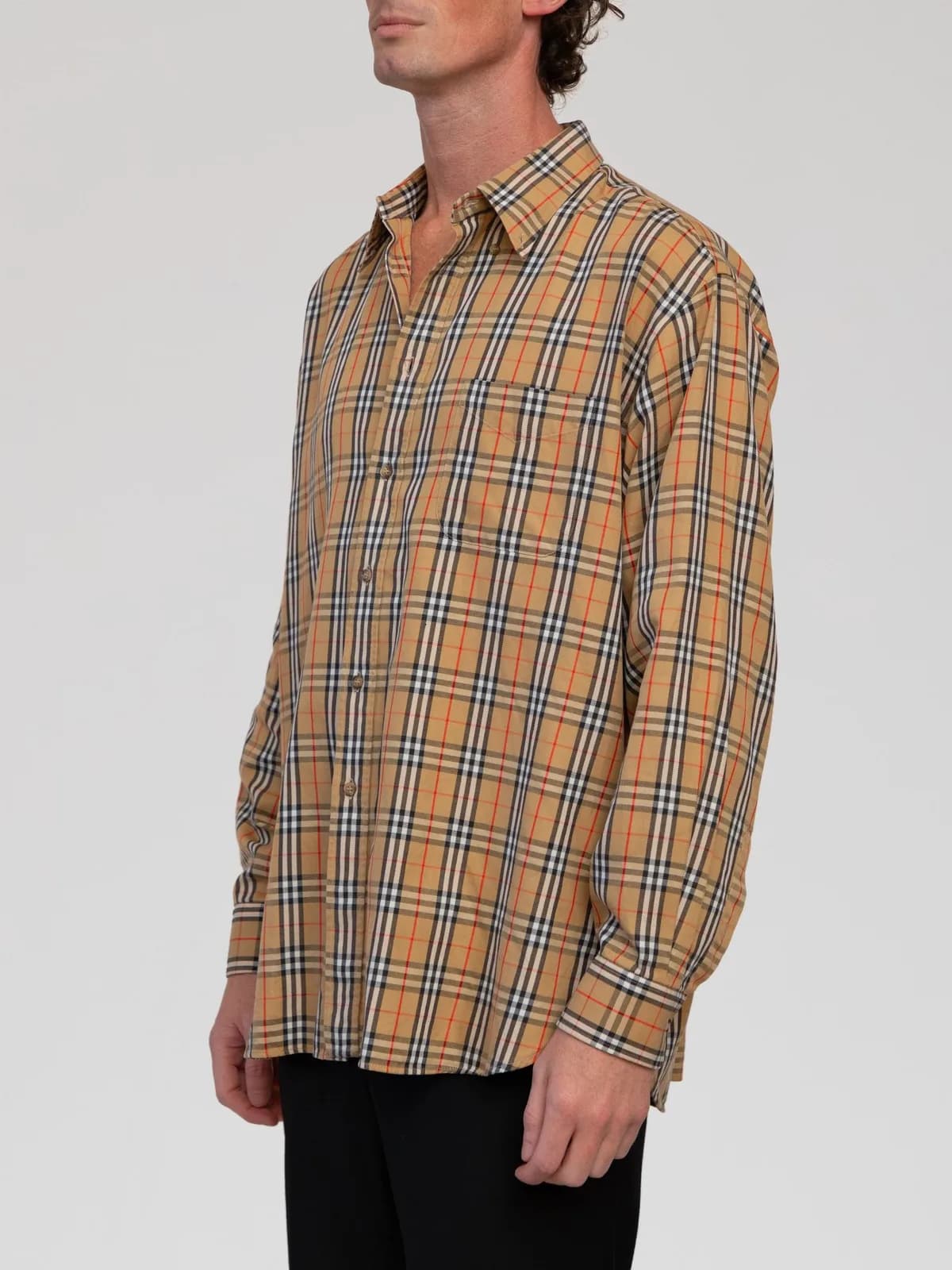 Vintage Burberrys of London long-sleeve button-up shirt in the signature Nova check plaid (beige, black, white, and red). Made in France from 100% cotton, featuring a point collar, front chest patch pocket, double-button barrel cuffs, and a box pleat back yoke. - Image 1