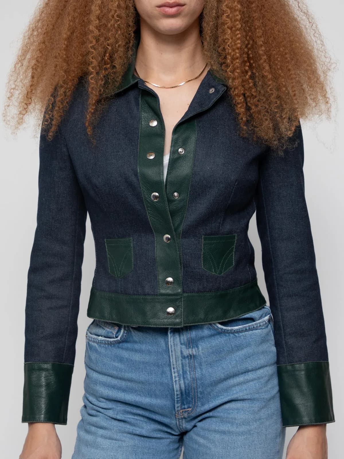 Early 00's navy denim jacket with contrasting brown leather trim, full pop button placard and front mini patch pockets in a cropped style - Image 1