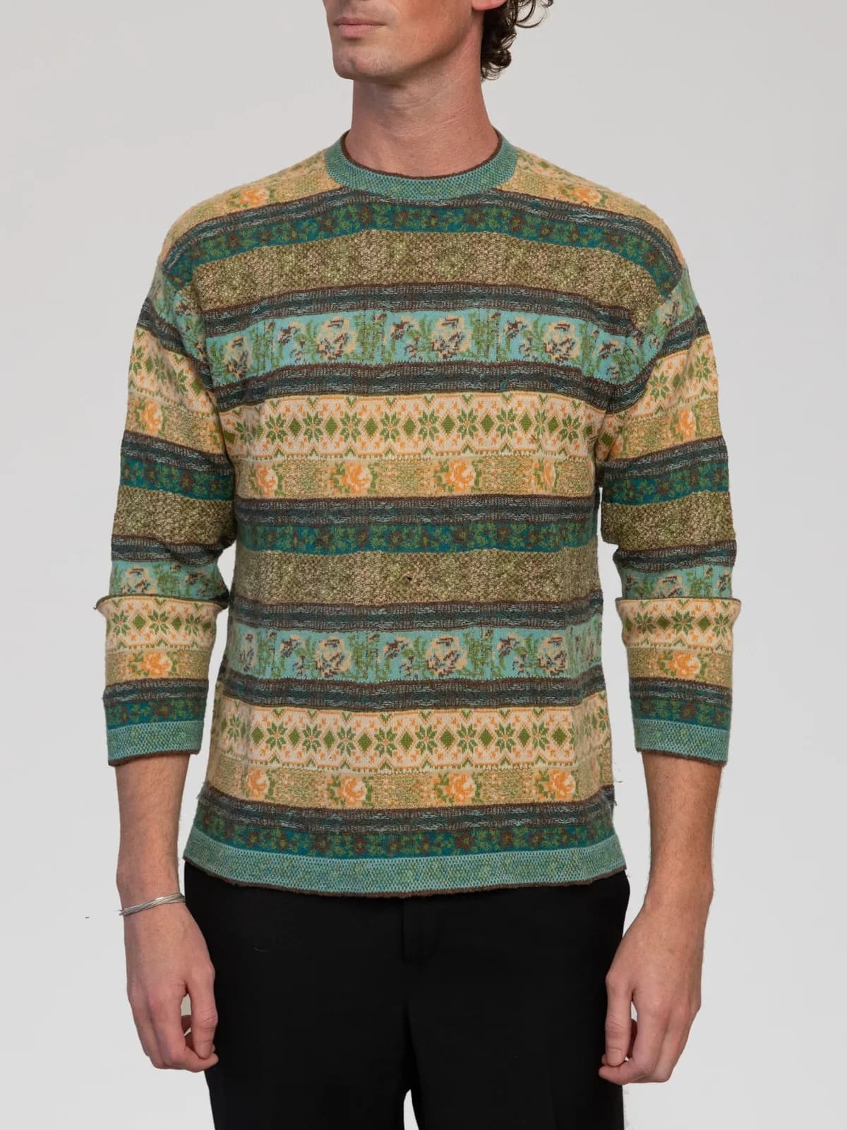 Vintage Kenzo Jungle long-sleeve knit sweater featuring an intricate multi-patterned Fair Isle and floral stripe jacquard design in rich tones of teal, olive green, ochre, and brown. Crafted from a soft wool blend, it is styled with a classic crew neck collar, regular fit, and fine ribbed trims. Made in Italy. - Image 1