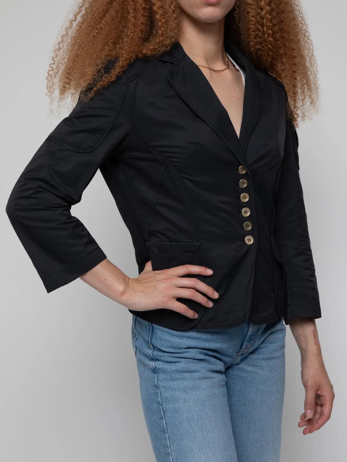 Late 00's black blazer style jacket with class 4 filling, featuring cargo style sleeve pocket, 6 buttons and a notce lapel - Image 1