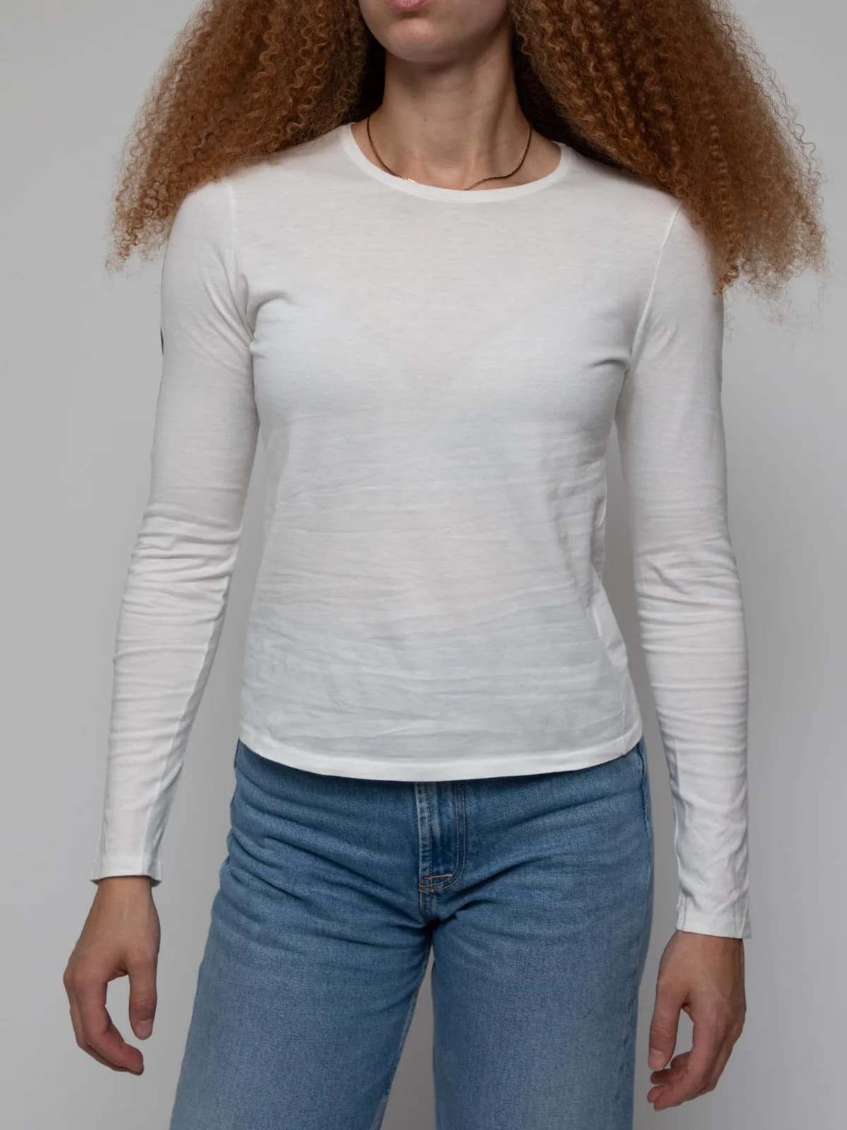 Mid 90's long sleeve white round neck t-shirt with cursive Gucci sprawled across the upper back leading to the Gucci stripe running down the right arm - Image 1