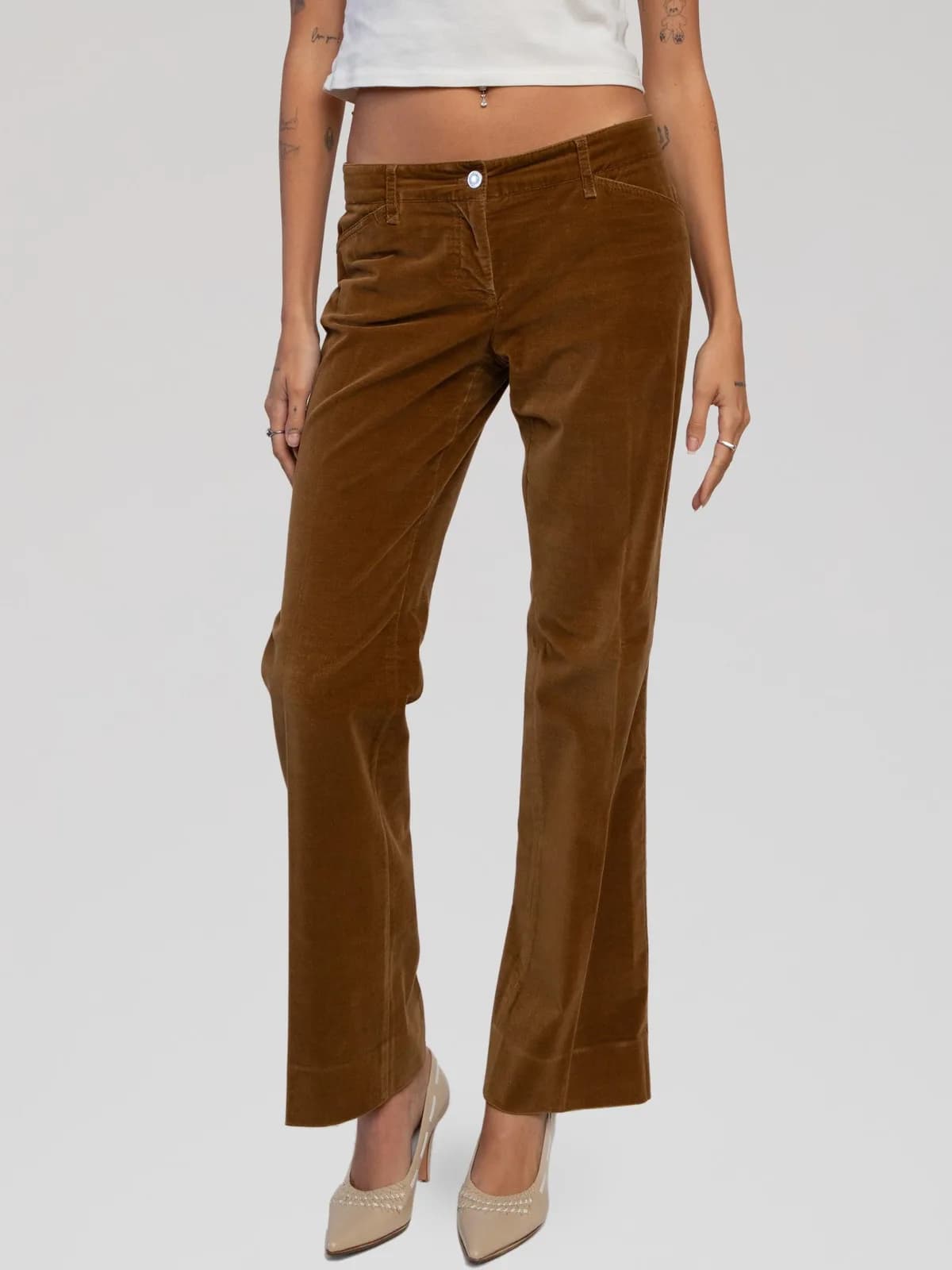 Vintage Dolce & Gabbana low-rise velvet corduroy trousers in a warm cognac brown. Cut with a straight-leg silhouette, featuring a zip fly with button closure, tonal stitching details, front patch pockets, rear patch pockets, and a dark brown leather logo patch embossed with "D&G" on the back right waistband. Made in Italy. - Image 1