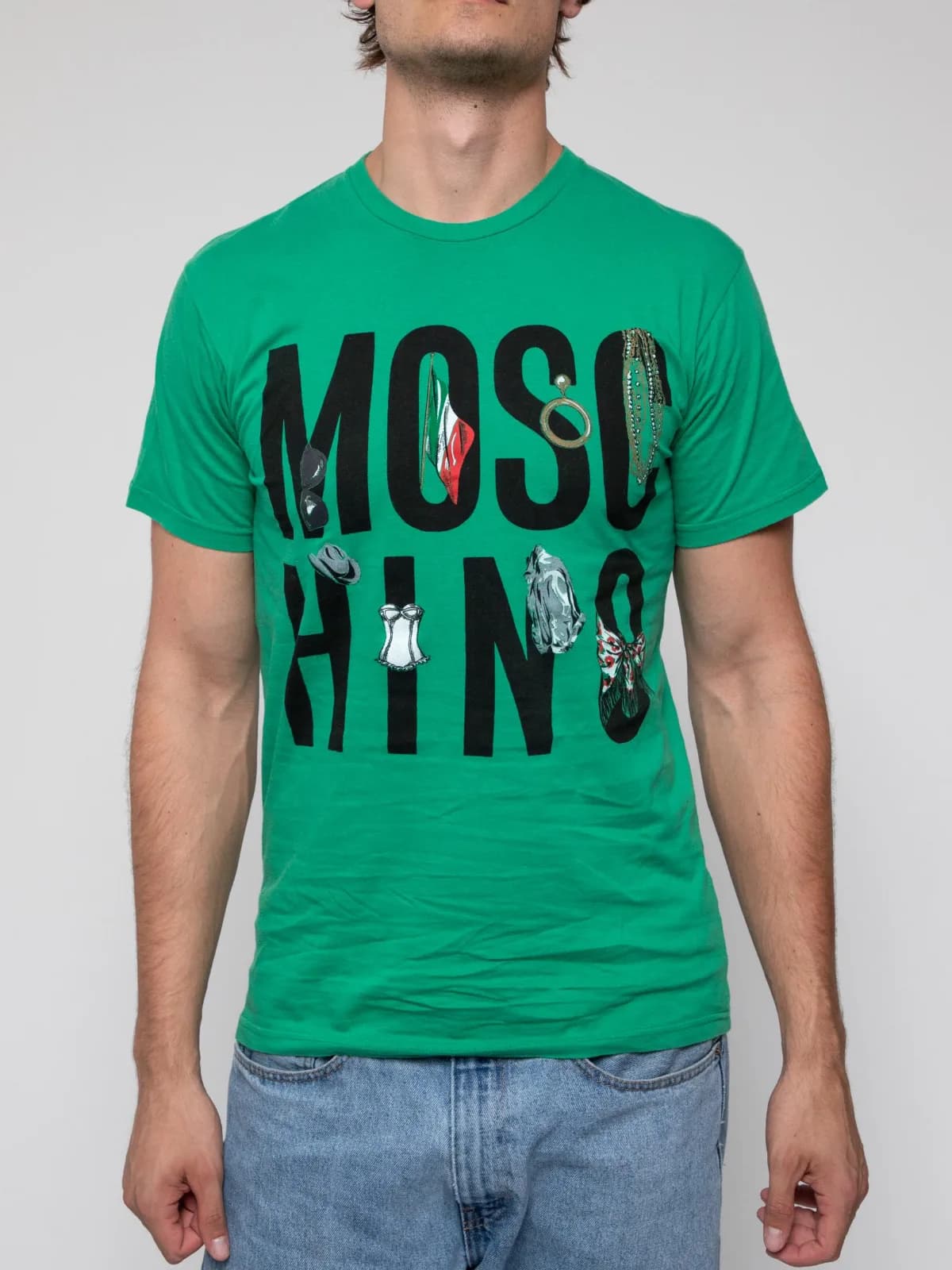 Mid 00s Green crew neck short sleeve t-shirt with large font "MOSCHINO" on the front decorated with women's clothing items - Image 1